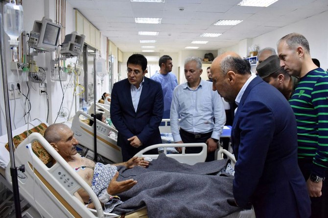 Syria’s health minister visits injured individuals in the aftermath of a drone attack targeting a Syrian military academy in Homs. (AFP)