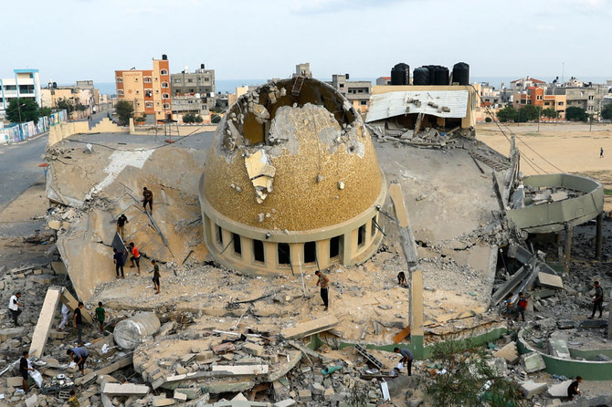 Palestinian inspect a mosque destroyed in Israeli strikes in Khan Younis in the southern Gaza Strip on Oct. 8, 2023. (Reuters)