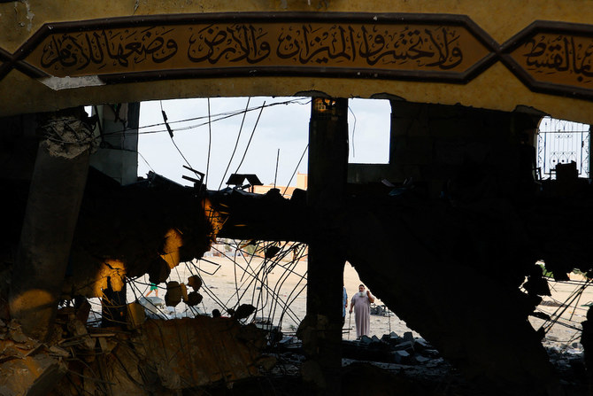 Above, a resident amid the debris of a mosque destroyed in Israeli strikes in Khan Younis in the southern Gaza Strip on Oct. 8, 2023. (Reuters)