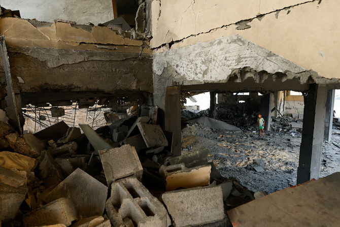 A boy walks amid the debris of a mosque destroyed in Israeli strikes in Khan Younis in the southern Gaza Strip on Oct. 8, 2023. (Reuters)