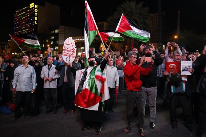 Iran, which does not recognize Israel and has made support for the Palestinian cause a centerpiece of its foreign policy, was one of the first countries to hail the Hamas assault. Above, Iranians attend a gathering in Tehran on Oct. 7, 2023 to express their solidarity with Palestine. (AFP)