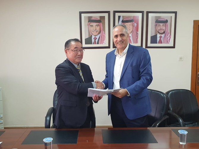 NEPCO General Manager Amjad Rawashdeh signs an agreement with Japan International Cooperation Agency. (Petra)