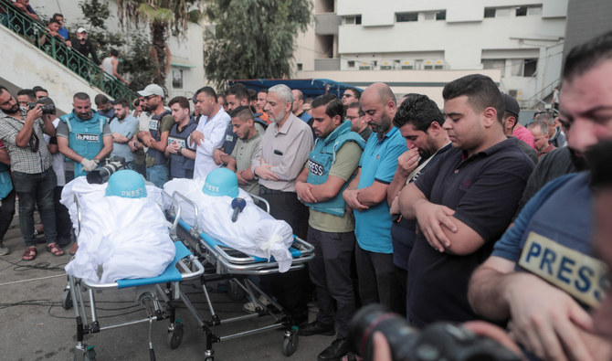 Media men attend in Gaza the funeral of journalists Said Al-Taweel and Mohammed Sobboh who were killed in an Israeli airstrike. (AFP)