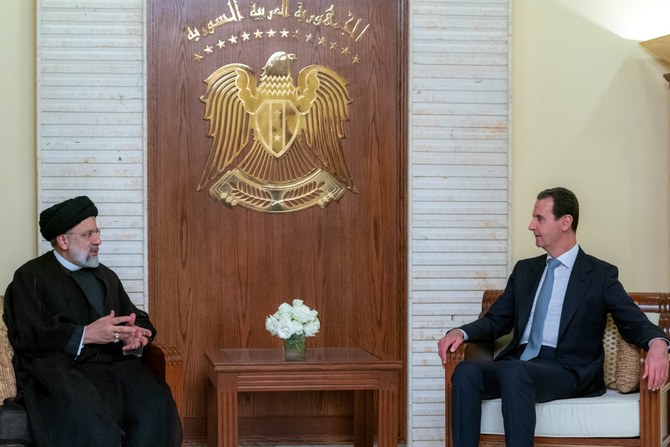 File Photo of President Bashar Assad and Iranian President Ebrahim Raisi (AFP)
