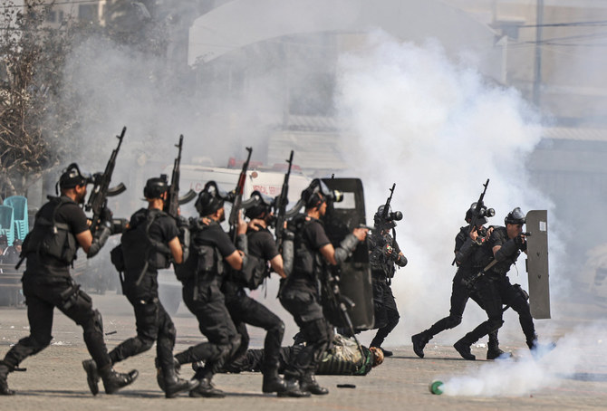 Members of the Palestinian security forces loyal to Hamas show their skills during a graduation ceremony in Gaza City on February 21, 2022. (AFP)