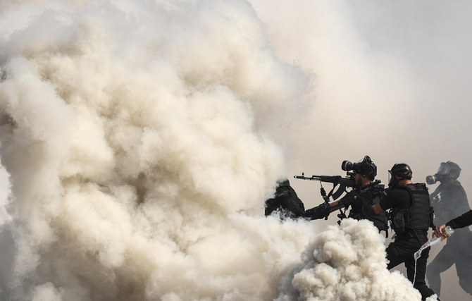 Members of the Palestinian security forces loyal to Hamas show their skills during a graduation ceremony in Gaza City on February 21, 2022. (AFP)