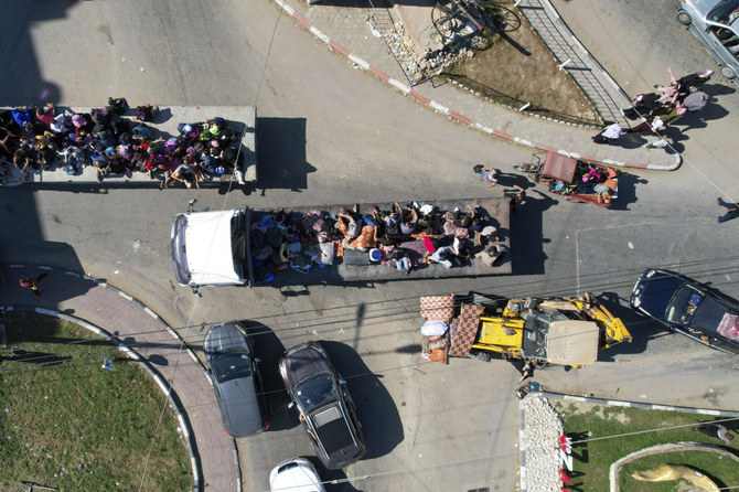 Palestinians fleeing from northern Gaza to the south after the Israeli army issued an unprecedented evacuation warning to a population of over 1 million people in northern Gaza and Gaza City to seek refuge in the south ahead of a possible Israeli ground invasion on Oct. 13, 2023. (AP)
