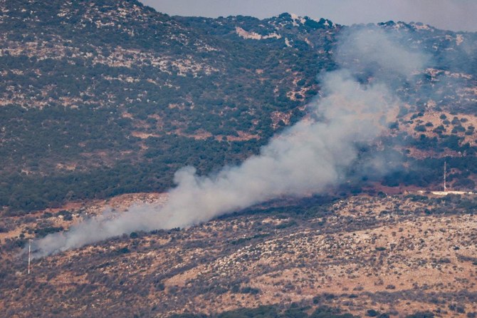 Smoke rises on hills in the border area of Shebaa farms after being hit by a rocket fired from southern Lebanon, on Oct. 14, 2023. (AFP)
