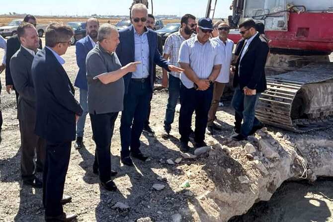 Syria's Prime Minister Hussein Arnous inspects damage at the runway of Damascus International Airport on the outskirts of the Syrian capital on October 13, 2023 after an Israeli air strike. (Syrian Arab News Agency handout/Telegram/AFP)
