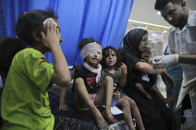 Palestinian children wounded in Israeli strikes are brought to Shifa Hospital in Gaza City on Oct. 11, 2023. (AP Photo/Ali Mahmoud)