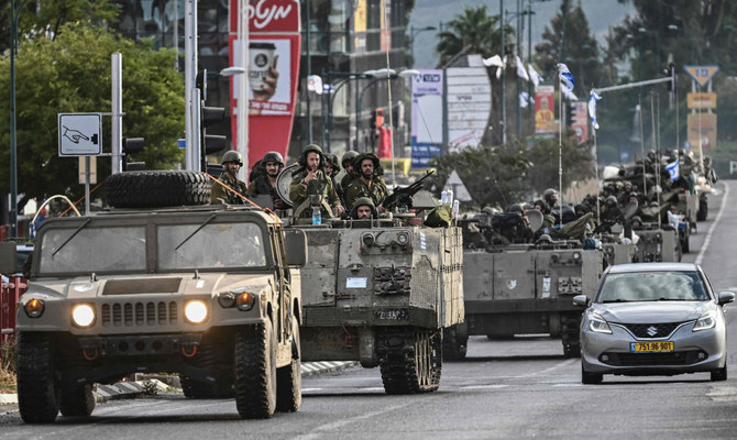 Israeli soldiers patrol in armoured personnel carriers at an undisclosed position in northern Israel near the border with Lebanon on October 15, 2023. (AFP)