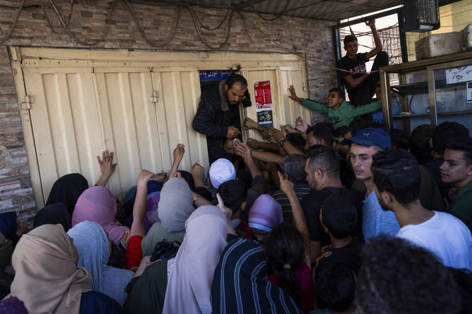 Palestinians crowding to buy bread from a bakery, in Khan Younis, Gaza Strip, on Oct. 15, 2023. (AP)