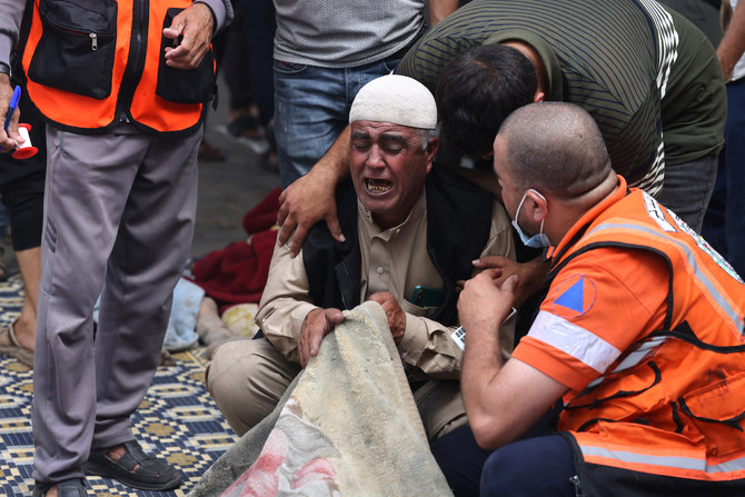 A Palestinian man reacts as he finds a family member following an Israeli airstrike on buildings in Rafah, in the southern Gaza Strip. (AFP)