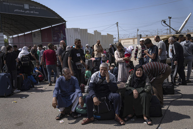 Palestinians wait to cross into Egypt at the Rafah border crossing in the Gaza Strip on Oct. 16, 2023. (AP)