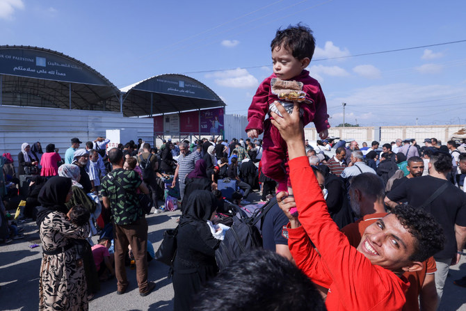 Palestinians, some with foreign passports hoping to cross into Egypt and others waiting for aid wait at the Rafah crossing in the southern Gaza strip, on October 16, 2023. (AFP)