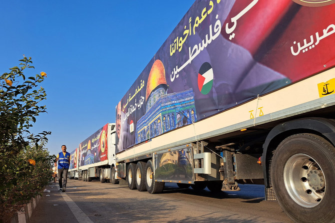 A convoy of trucks carrying aid supplies for Gaza from Egypt waits on the main Ismailia desert road on the way to the Rafah crossing on October 16, 2023. (AFP)