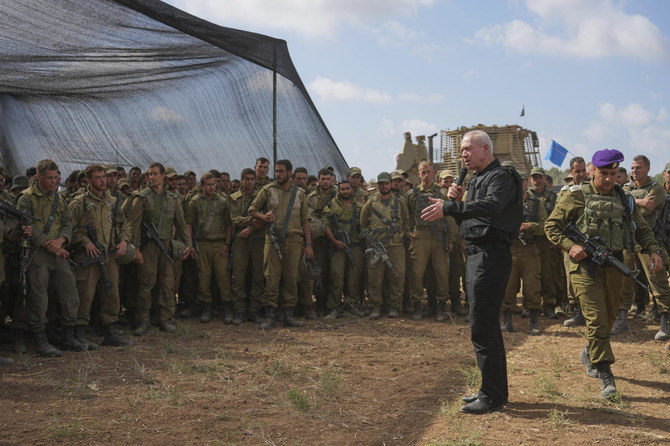 Israel's Defense Minister Yoav Gallant, wearing a protective vest, speaks with Israeli soldiers in a staging area near the border with the Gaza Strip in southern Israel. (File/AP)