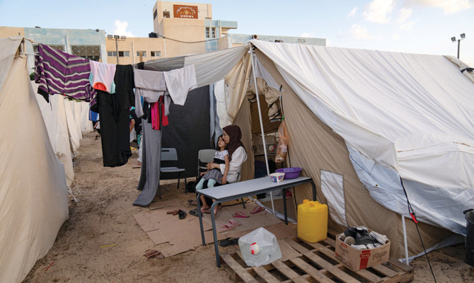The construction of the tent city in Khan Younis to shelter scores of Palestinians who lost or fled their homes during the past days of intense Israeli bombardment has elicited anger, disbelief and sorrow across the Arab world. (AP)