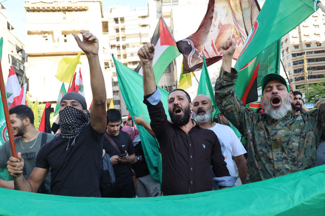 Supporters of the Lebanese Shiite movements Hezbollah and Amal attend gather in the southern suburb of Beirut on October 20, 2023, to show solidarity with the Palestinian people. (AFP)