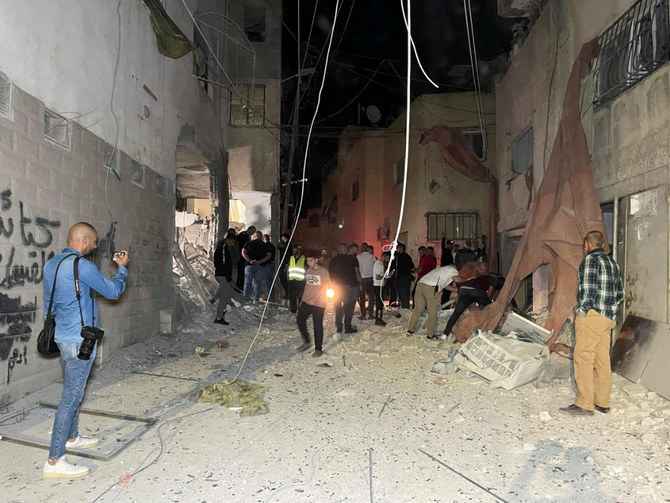 People inspect the damage after an Israeli strike hit a compound beneath a mosque at the Jenin refugee camp in the Israeli-occupied West Bank on October 22, 2023. The Israeli military said the compound was being used by militants to organize attacks. (REUTERS)