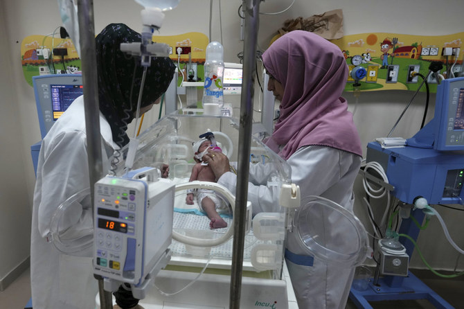 Palestinian doctors attend to a prematurely born baby at Al Aqsa Hospital in Deir el-Balah, Gaza Strip, on Oct. 22, 2023. (AP Photo/Adel Hana)