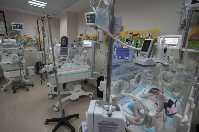 A doctor attends to prematurely born babies at Al Aqsa Hospital in Deir el-Balah, Gaza Strip, on Oct. 22, 2023. (AP Photo/Adel Hana)