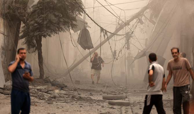 Palestinians inspect the destruction in a neighbourhood heavily damaged by Israeli airstrikes on Gaza City’s Al-Shati refugee camp early on October 9, 2023. (AFP/File)
