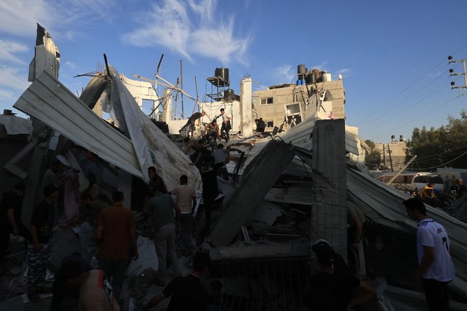 Palestinians inspect the debris after an Israeli strike near an United Nations Relief and Works Agency for Palestine Refugees (UNRWA) school in Khan Yunis, in the southern Gaza Strip on October 21, 2023. (AFP)