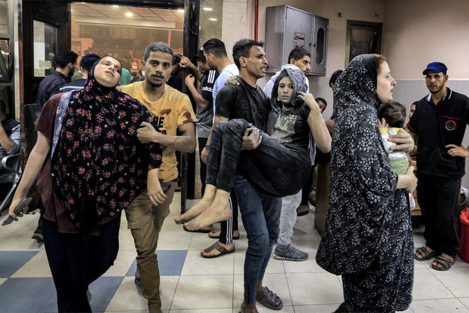 Above, Gaza residents arrive for treatment at Nasser hospital in Khan Yunis after an Israeli bombardment. (AFP)