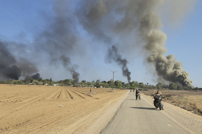 Palestinians walk and drive away from Kibbutz Kfar Azza, Israel, near the fence with the Gaza strip following a deadly attack on the community on Oct. 7, 2023. (AP Photo)