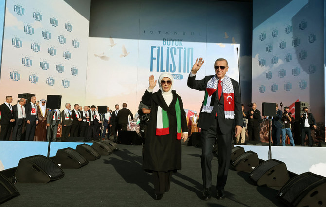 Turkish President Recep Tayyip Erdogan (R) and his wife Emine greet supporters during a rally in Istanbul on October 28, 2023, organized by the AKP party in solidarity with the Palestinians in Gaza. (Turkish Presidency handout photo/via AFP)