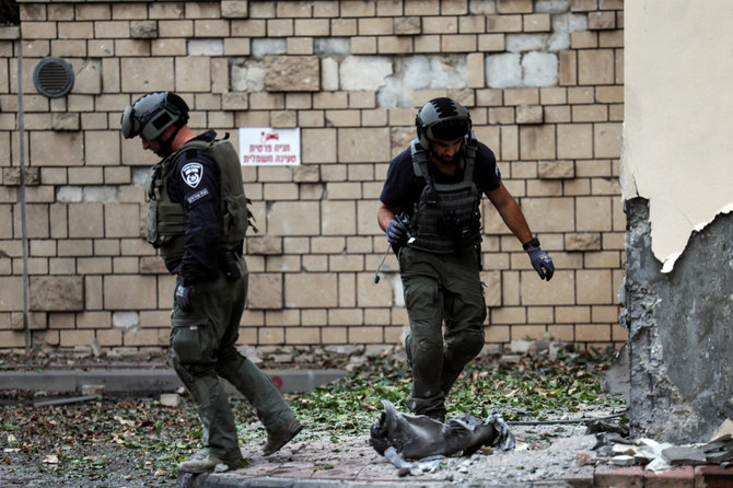 Israeli police inspect the damage caused by a rocket after it was fired from the Gaza Strip towards Israel. (Reuters)