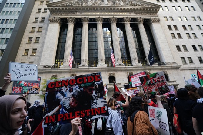 Protesters hold signs and flags during the 