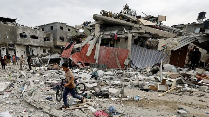 A child walks at the site of an Israeli airstrike on a house, as the conflict between Israel and Palestinian group Hamas continues, in Khan Younis in the southern Gaza Strip, October 27, 2023. (Reuters)
