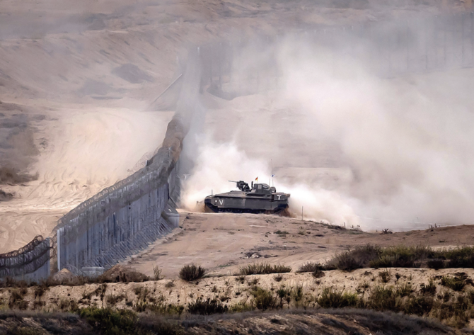 An Israeli tank crossing the border into the Gaza strip amid ongoing battles between Israeli forces and Hamas. Gaza’s possible return to Israeli control raises questions about what responsibilities occupying power would have. (AFP)