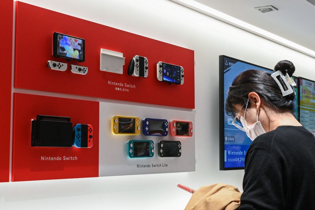 A woman looks at a Nintendo Switch display at a Nintendo store in central Tokyo on November 6, 2023. The Japanese gaming giant is expected to announce second quarter earnings on November 7. (Photo by Richard A. Brooks / AFP)