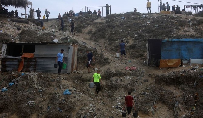 Palestinians use sea water to bathe and wash their clothes due the continuing water shortage in Gaza, Oct. 29, 2023. (AP Photo)