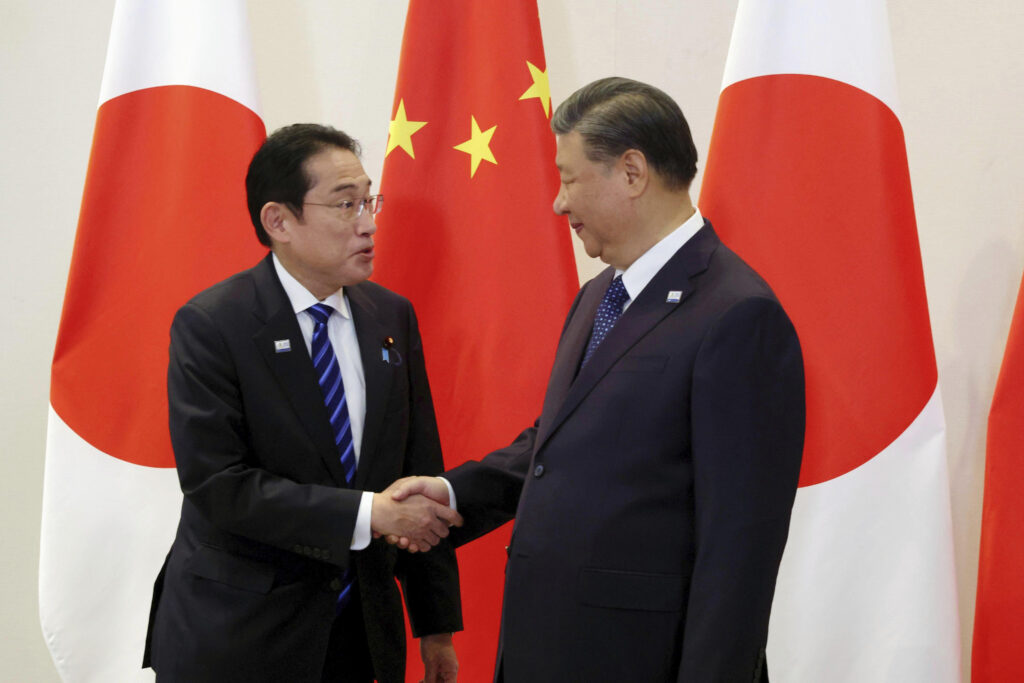 Japanese Prime Minister Fumio Kishida, left, and Chinese President Xi Jinping shake hands prior to their bilateral talk on the sidelines of the Asia-Pacific Economic Cooperation summit, in San Francisco, Thursday, Nov. 16, 2023. (Kyodo News via AP)