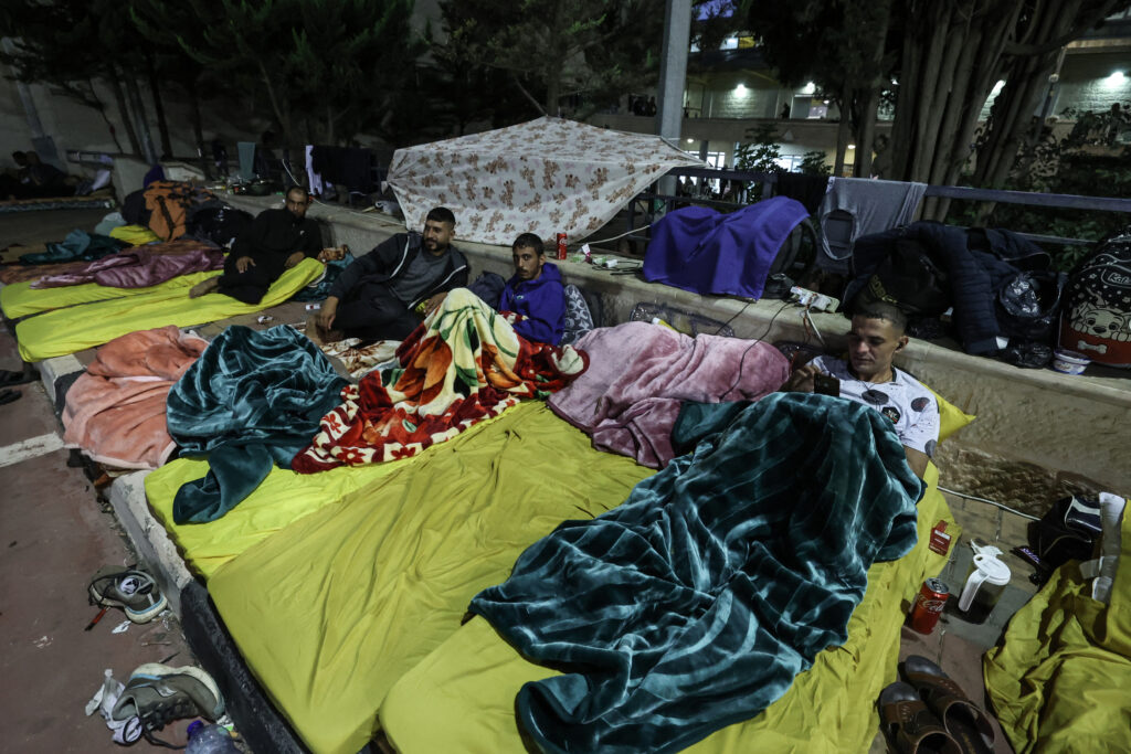 Workers from the Gaza Strip who had crossed to Israel to work before the October 7 attack by Hamas, rest in a temporary shelter in a sport complex in the occupied West Bank city of Ramallah, after being expelled from Israel, on November 8, 2023. (AFP)