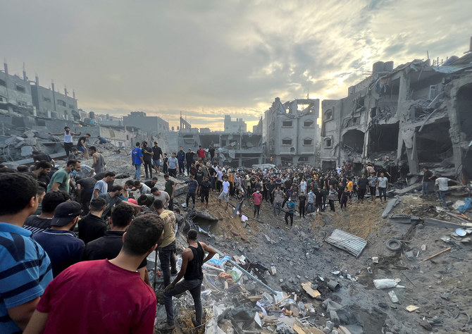 Palestinians search for casualties at the site of Israeli strikes on houses in Jabalia refugee camp in the northern Gaza Strip, October 31, 2023. (Reuters)