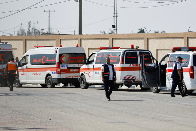 Medical workers wait to take injured Palestinians who will receive treatment in Egyptian hospitals, at the Rafah border crossing with Egypt, in the southern Gaza Strip, on Nov. 1, 2023. (Reuters)