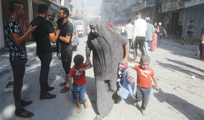 Palestinians evacuate civilians following an Israeli airstrike in the Gaza Strip. The death toll from nearly four weeks of air and artillery strikes has risen past 9,000. (AP)