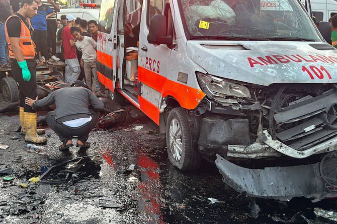 A dead horse lies on the ground as people gather around an ambulance damaged in a reported Israeli strike in front of Al-Shifa hospital in Gaza City on November 3, 2023, as battles between Israel and the Palestinian Hamas movement continue. (AFP)