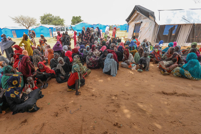 Women who fled the war in Sudan await the distribution of international aid rations at the Ourang refugee camp, near Adre town in eastern Chad on August 15, 2023. The Joint Human Rights Office in Sudan says it has received credible reports of more than 50 incidents of sexual violence linked to the conflict. (AFP)