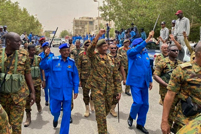 Sudan Armed Forces chief General Abdel Fattah al-Burhan (C) walks with other army officials during a tour of a neighborhood in Port Sudan, in the Red Sea state, on. (Sudanese Army photo handout/via AFP)