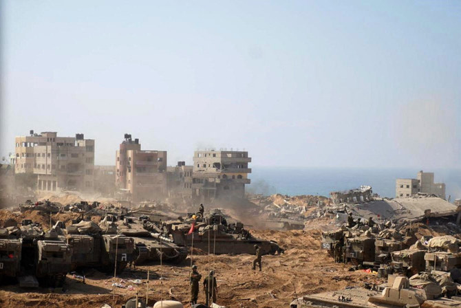 This handout picture released by the Israeli army on November 5, 2023, shows Israeli tanks and soldiers stationed at a location in the northern Gaza Strip as battles between Israel and the Palestinian Hamas movement continue. (AFP)