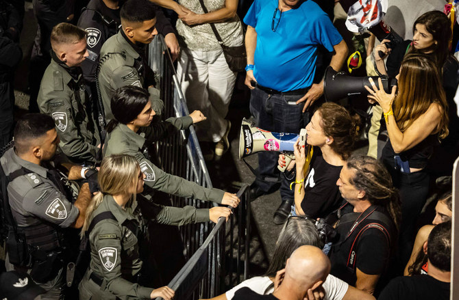 Security forces block Israeli demonstrators shouting slogans against Prime Minister Benjamin Netanyahu during an anti-government protest in Jerusalem on November 4, 2023, amid the ongoing battles between Israel and the Palestinian group Hamas. (AFP)