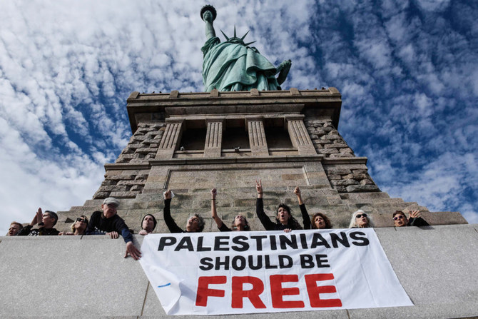 Activists from Jewish Voice for Peace occupy the pedestal of the Statue of Liberty on November 6, 2023 in New York City. (AFP)