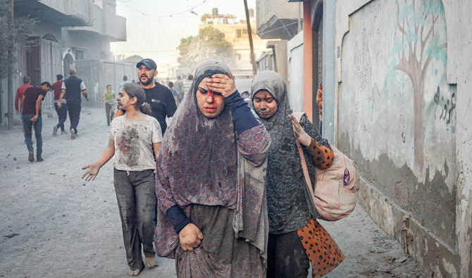 Palestinians walk away after an Israeli airstrike in Rafah, Gaza Strip, on Tuesday. (AP)