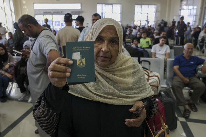 Palestinian dual nationals and foreigners have been waiting to cross the Rafah border crossing with Egypt, in the southern Gaza Strip. (AFP)